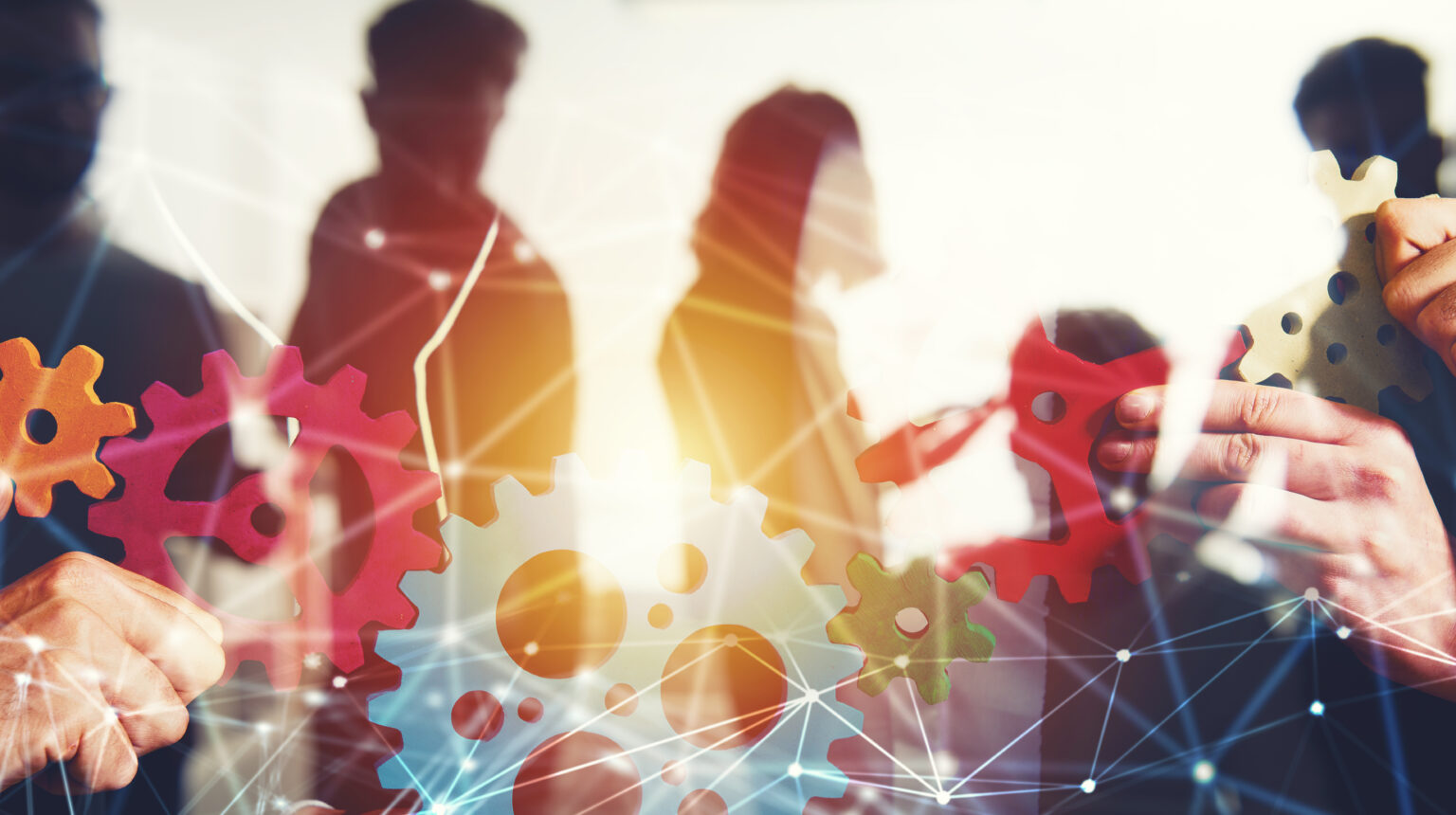 Business team connect pieces of gears. Teamwork, partnership and integration concept with network effect. double exposure Teamwork of businesspeople work together and combine pieces of gears. Partnership and integration concept with nerwork effect. double exposure